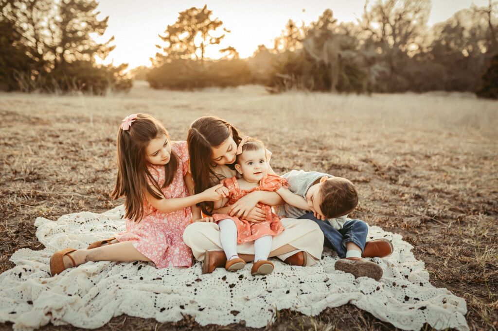 Three siblings at golden hour with a Frisco TX family photographer